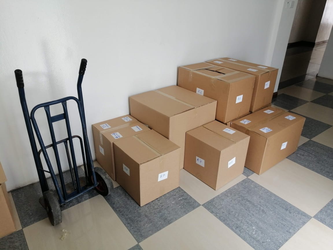 Neatly labelled moving boxes ready for transport
